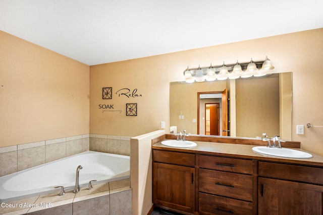 bathroom featuring tiled bath and vanity