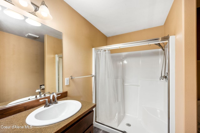 bathroom featuring a shower with curtain and vanity