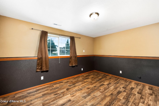 unfurnished room featuring hardwood / wood-style flooring