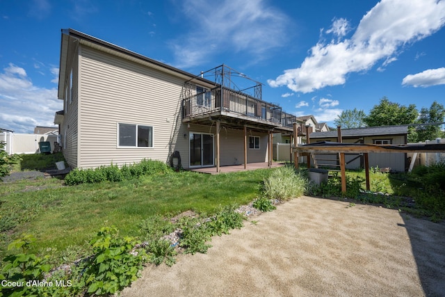 rear view of property with a lawn and a wooden deck