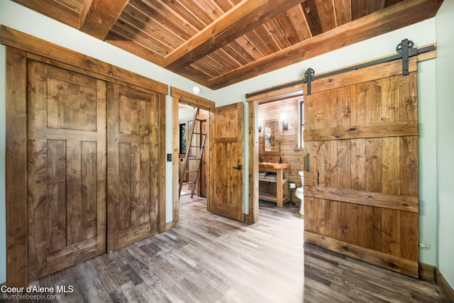 hallway featuring hardwood / wood-style floors, wood ceiling, beam ceiling, and a barn door