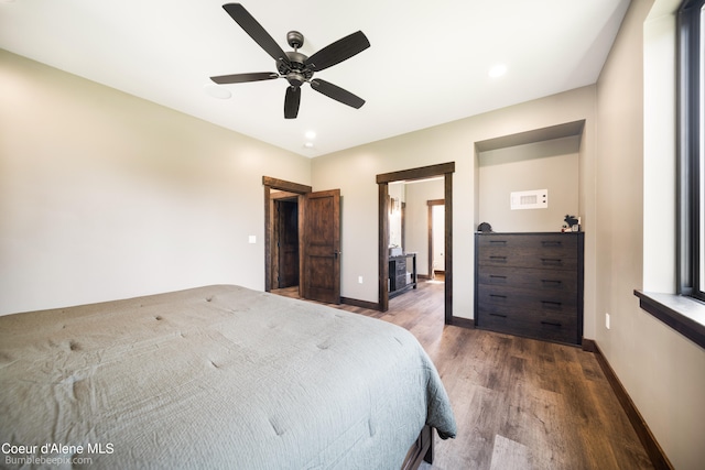 unfurnished bedroom with ceiling fan and dark wood-type flooring