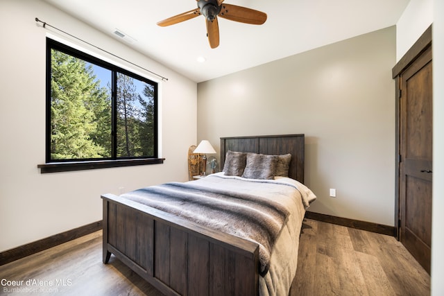 bedroom with light wood-type flooring and ceiling fan