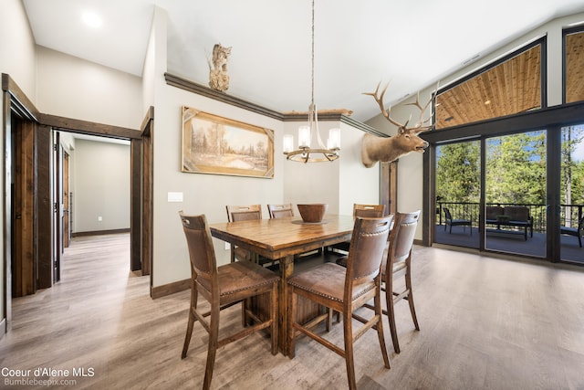 dining room featuring a notable chandelier and light wood-type flooring