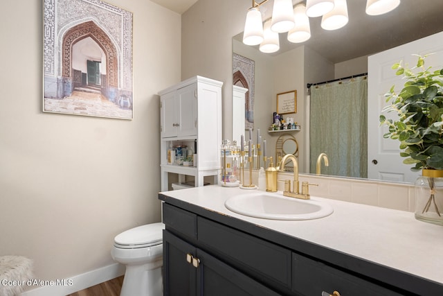 bathroom featuring vanity, hardwood / wood-style floors, and toilet