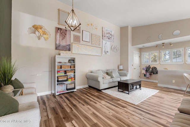 living room with hardwood / wood-style floors and a chandelier