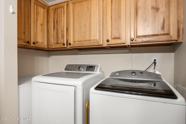 laundry area with cabinets and washing machine and clothes dryer