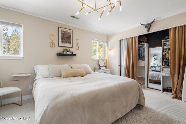 bedroom featuring an inviting chandelier, a closet, carpet flooring, and crown molding