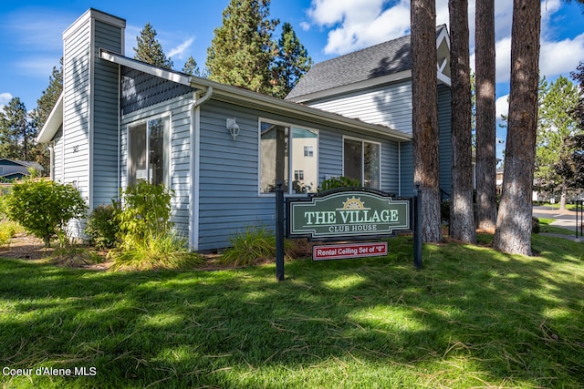 community sign featuring a lawn