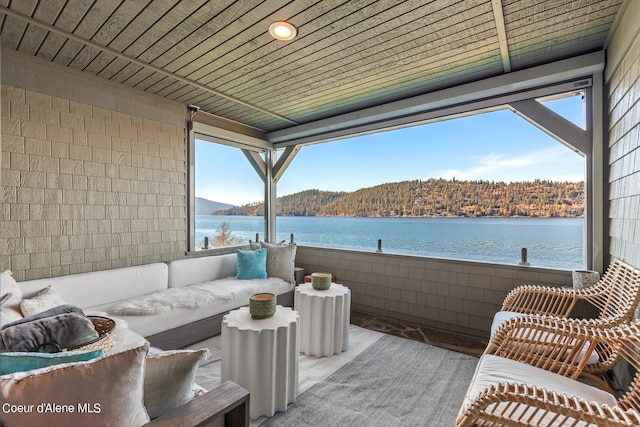 view of patio / terrace featuring outdoor lounge area and a water and mountain view