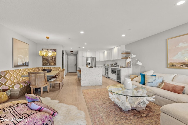 living room with wine cooler and light wood-type flooring