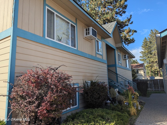 view of side of property featuring a wall mounted air conditioner