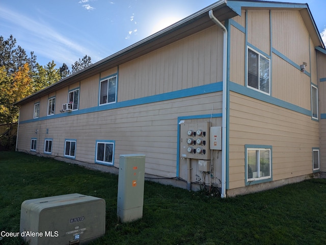 view of home's exterior featuring cooling unit and a yard