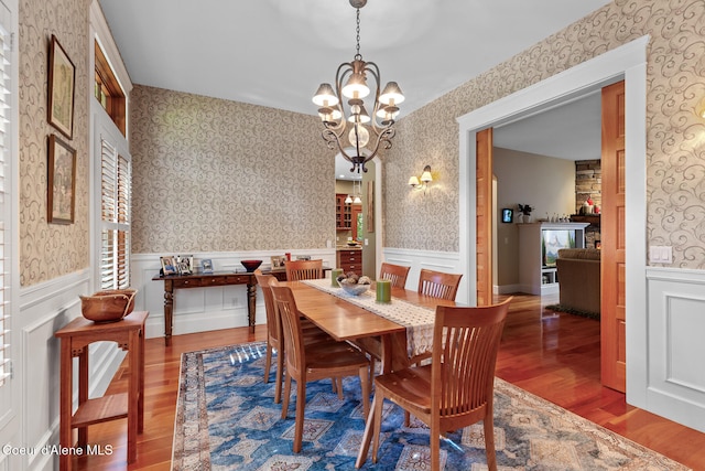 dining space featuring an inviting chandelier, hardwood / wood-style flooring, and plenty of natural light