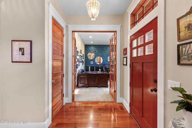 interior space with an inviting chandelier and hardwood / wood-style flooring