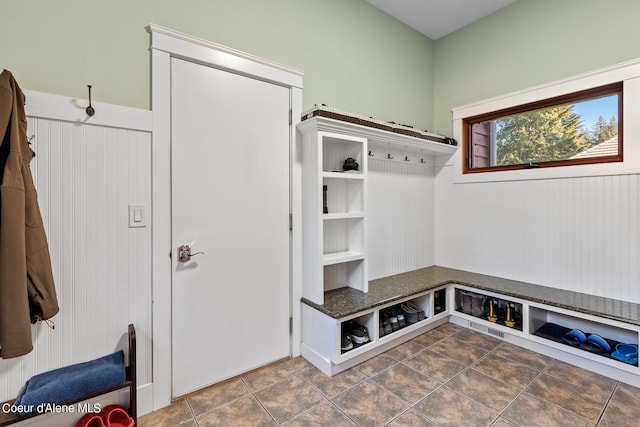 mudroom featuring dark tile patterned floors