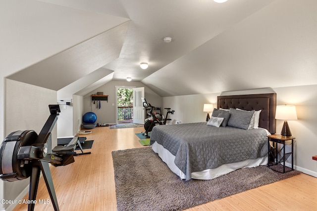 bedroom with lofted ceiling and hardwood / wood-style floors