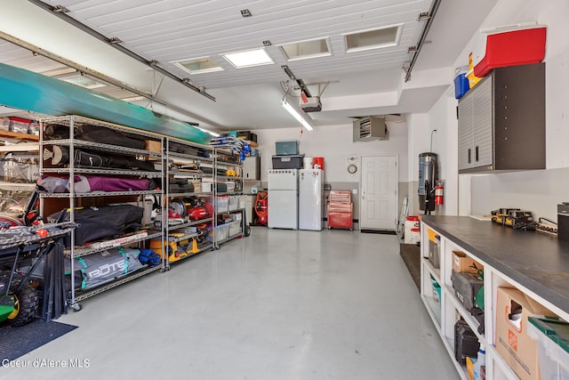 garage with white refrigerator and a garage door opener