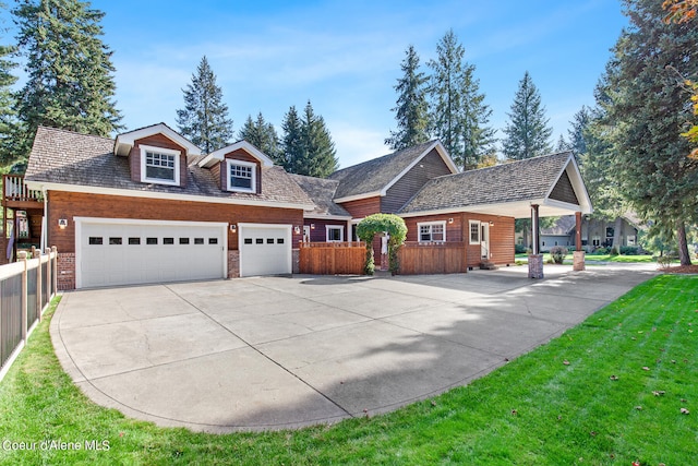 view of front of property featuring a garage and a front lawn