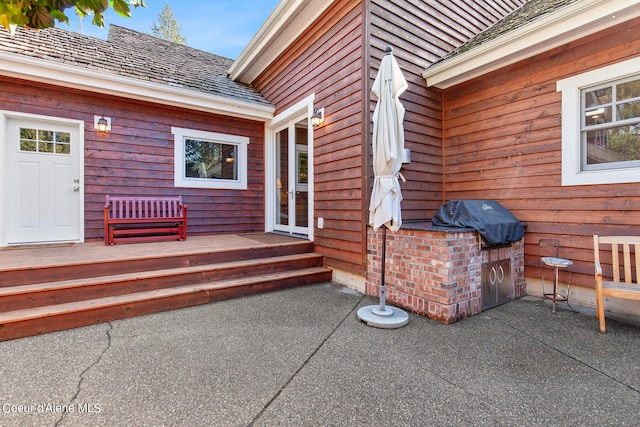 view of exterior entry featuring a patio area