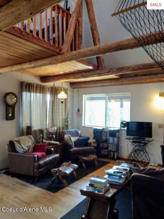 living room with wood-type flooring and wooden ceiling