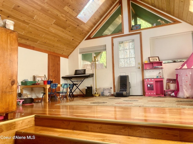 additional living space featuring wood-type flooring, lofted ceiling with skylight, and wood ceiling