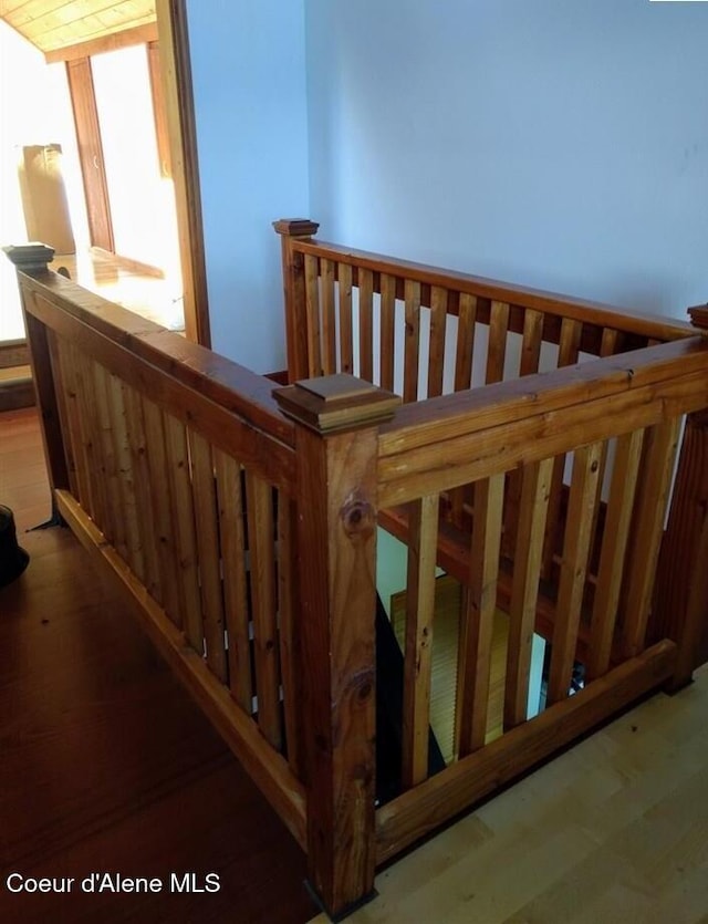 staircase with hardwood / wood-style floors