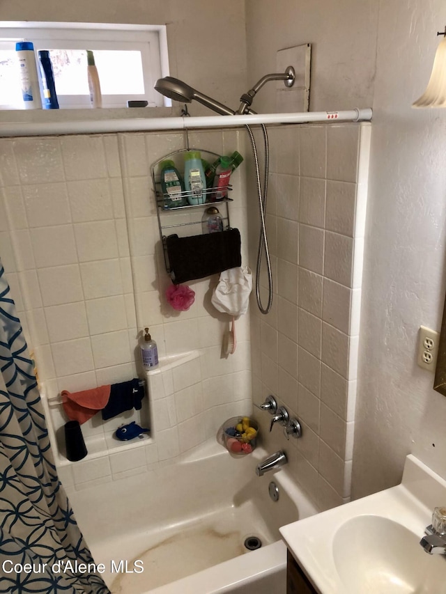 bathroom with shower / bath combo with shower curtain and vanity