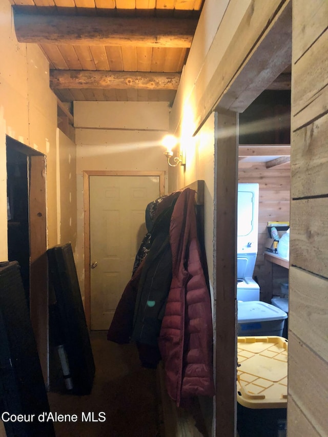 corridor featuring wood walls, beamed ceiling, and wooden ceiling