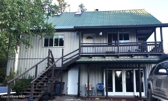 1452 Grizzly Gap Rd, Naples, ID 83847 - back of house with a balcony, french doors, stairs, board and batten siding, and metal roof