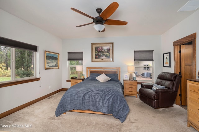 bedroom with light carpet, ceiling fan, and multiple windows