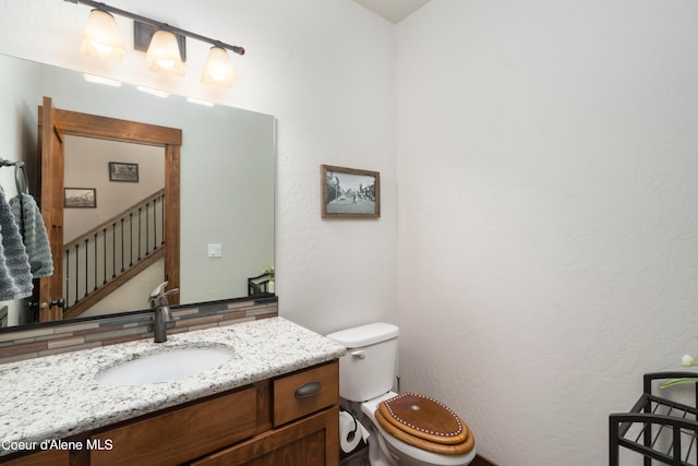 bathroom with toilet and vanity