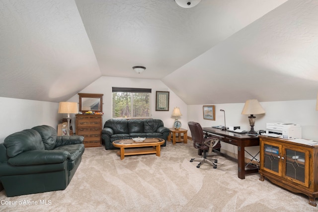 carpeted office with a textured ceiling and lofted ceiling