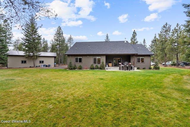 rear view of property with a patio and a yard