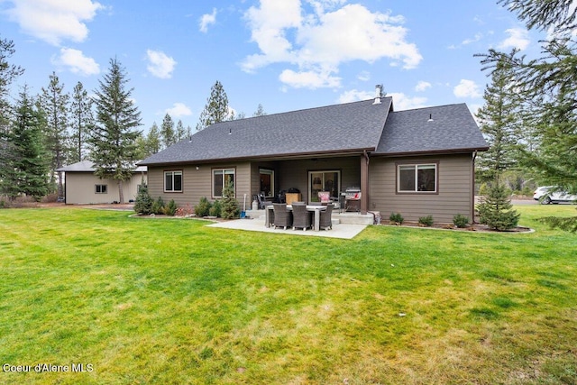 rear view of house with a yard and a patio