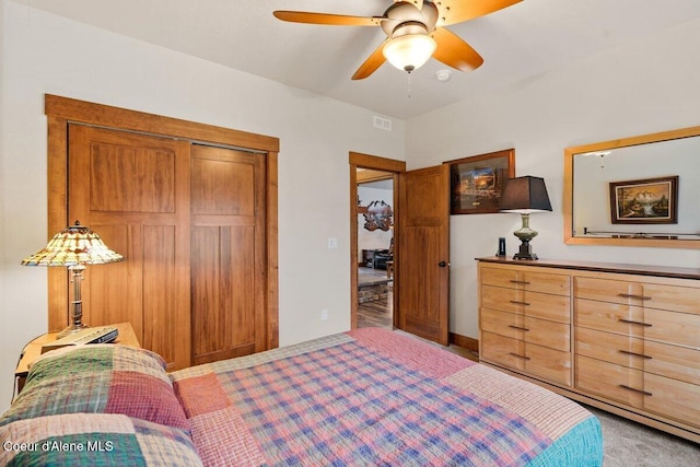 bedroom with ceiling fan, a closet, and carpet floors