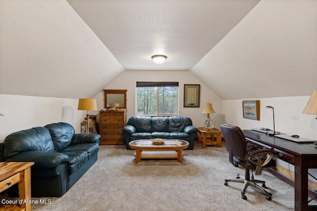 carpeted office space featuring a textured ceiling and lofted ceiling