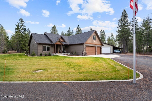 view of front of house with a garage and a front lawn