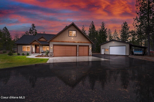 craftsman-style house featuring a garage and a yard