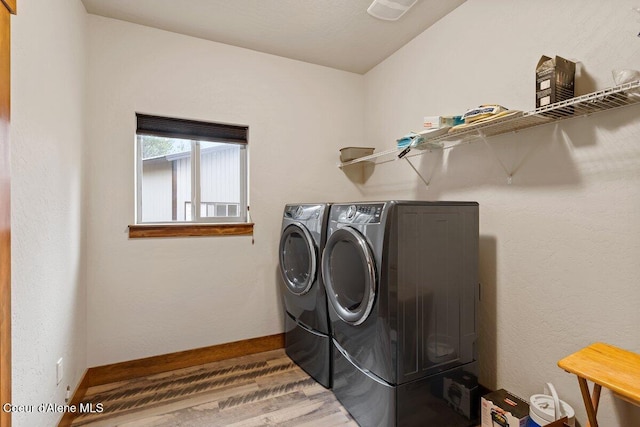 washroom with washer and clothes dryer and wood-type flooring