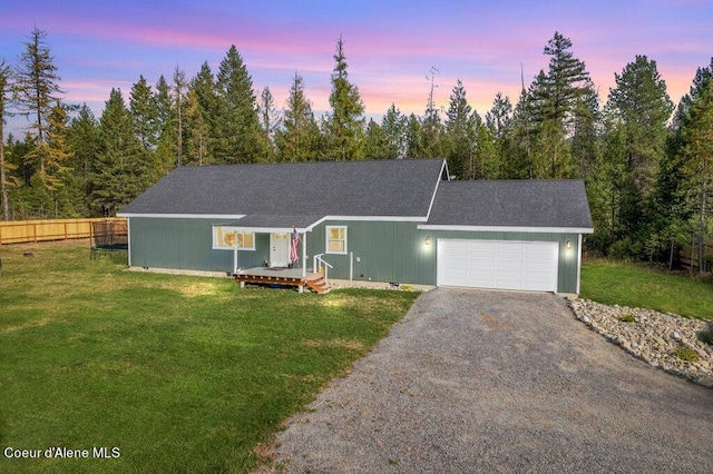 view of front of property featuring a garage and a lawn