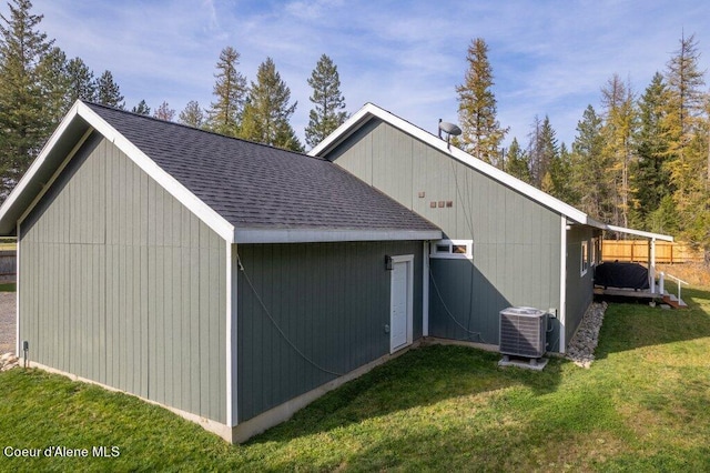 view of outdoor structure featuring a yard and cooling unit