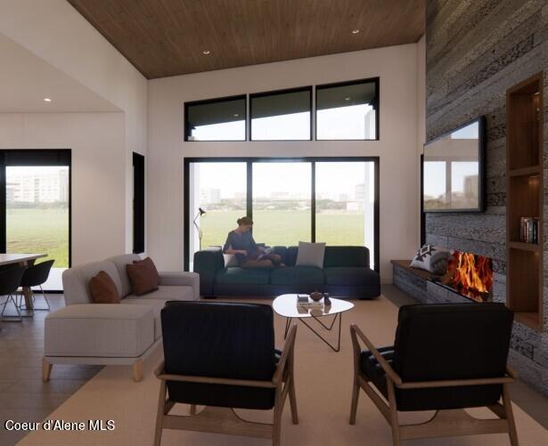15374 S Chalone Dr, Coeur Dalene, ID 83814 - living area with wood ceiling, wood finished floors, a towering ceiling, and a large fireplace