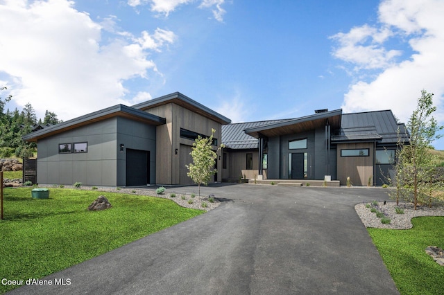 15374 S Chalone Dr, Coeur Dalene, ID 83814 - contemporary home with a standing seam roof, a garage, a metal roof, a front lawn, and asphalt driveway