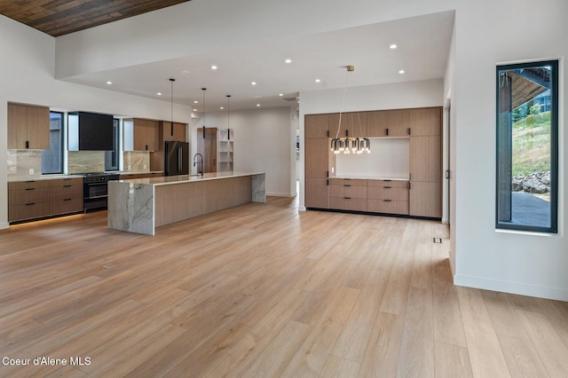 15374 S Chalone Dr, Coeur Dalene, ID 83814 - kitchen with modern cabinets, freestanding refrigerator, light countertops, recessed lighting, and backsplash