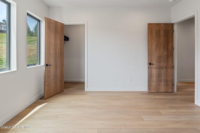 15374 S Chalone Dr, Coeur Dalene, ID 83814 - unfurnished bedroom with a walk in closet and light wood finished floors
