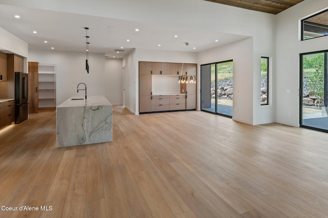 15374 S Chalone Dr, Coeur Dalene, ID 83814 - kitchen featuring modern cabinets, freestanding refrigerator, healthy amount of natural light, light wood-style floors, and recessed lighting