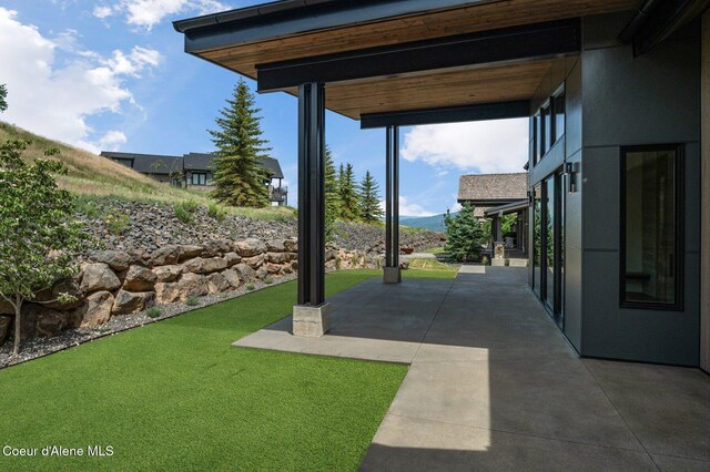 15374 S Chalone Dr, Coeur Dalene, ID 83814 - view of green lawn with a patio area and a mountain view