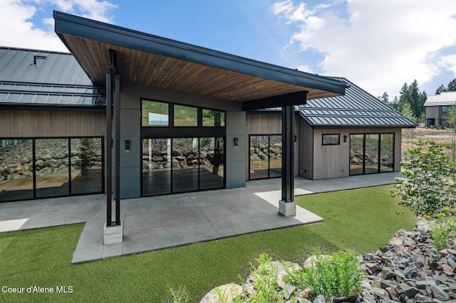 15374 S Chalone Dr, Coeur Dalene, ID 83814 - back of house with a standing seam roof, a patio area, and a metal roof