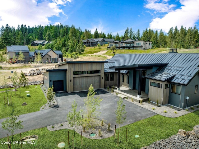 15374 S Chalone Dr, Coeur Dalene, ID 83814 - contemporary home featuring a standing seam roof, a metal roof, a residential view, and a detached garage